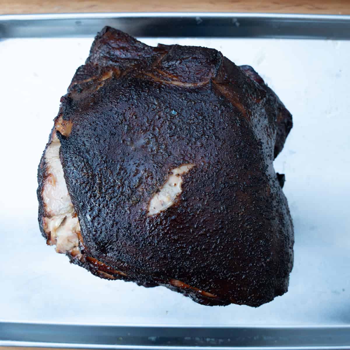 A smoked pork butt fresh off of the smokeand taken out of the wrap