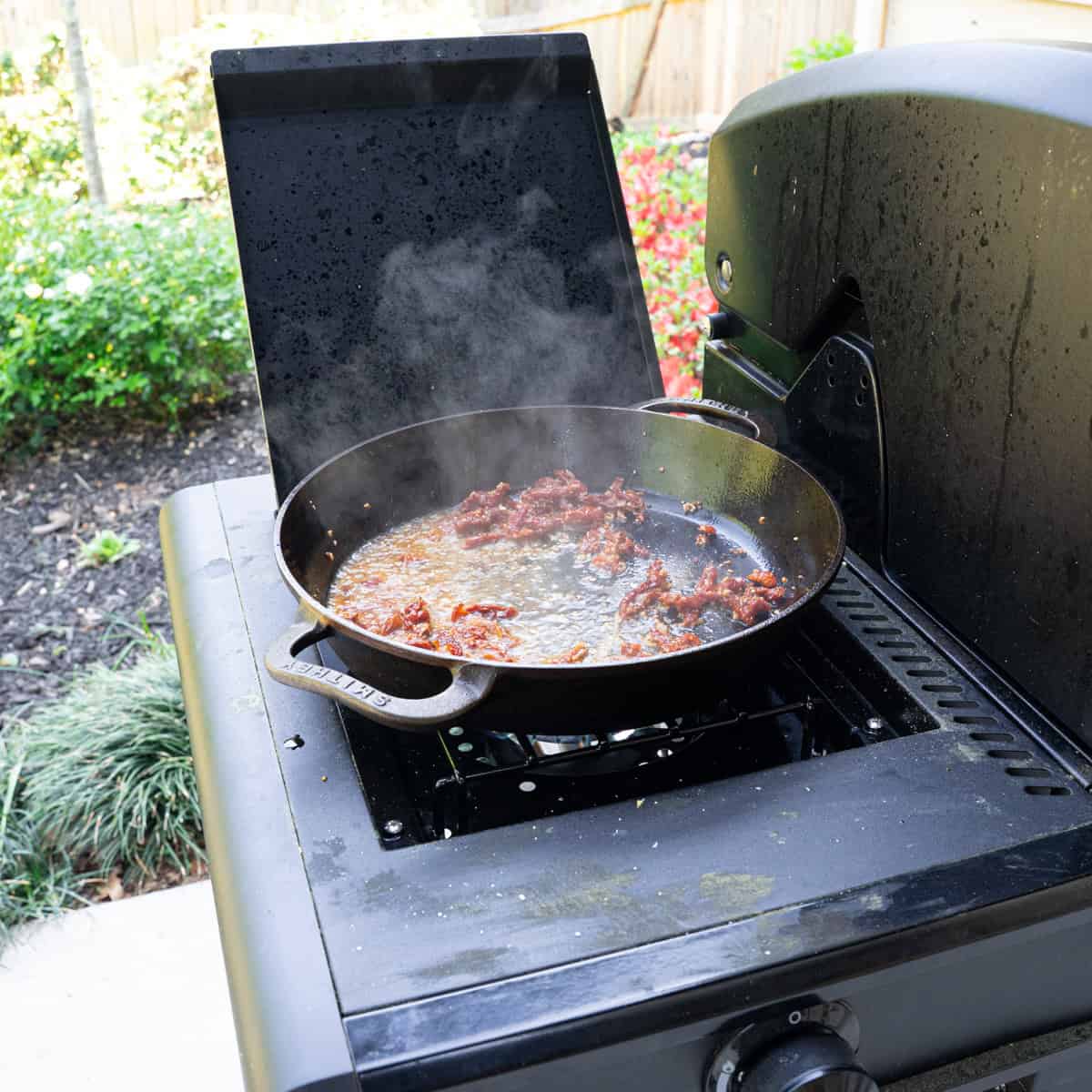 Reducing wine in a skillet with sun dried tomatoes